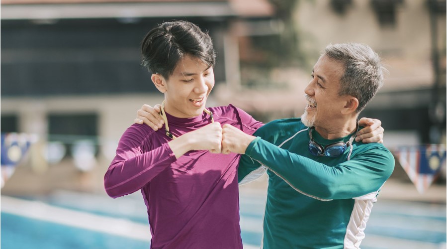 after swimming, a father and a son are celebrating the victory